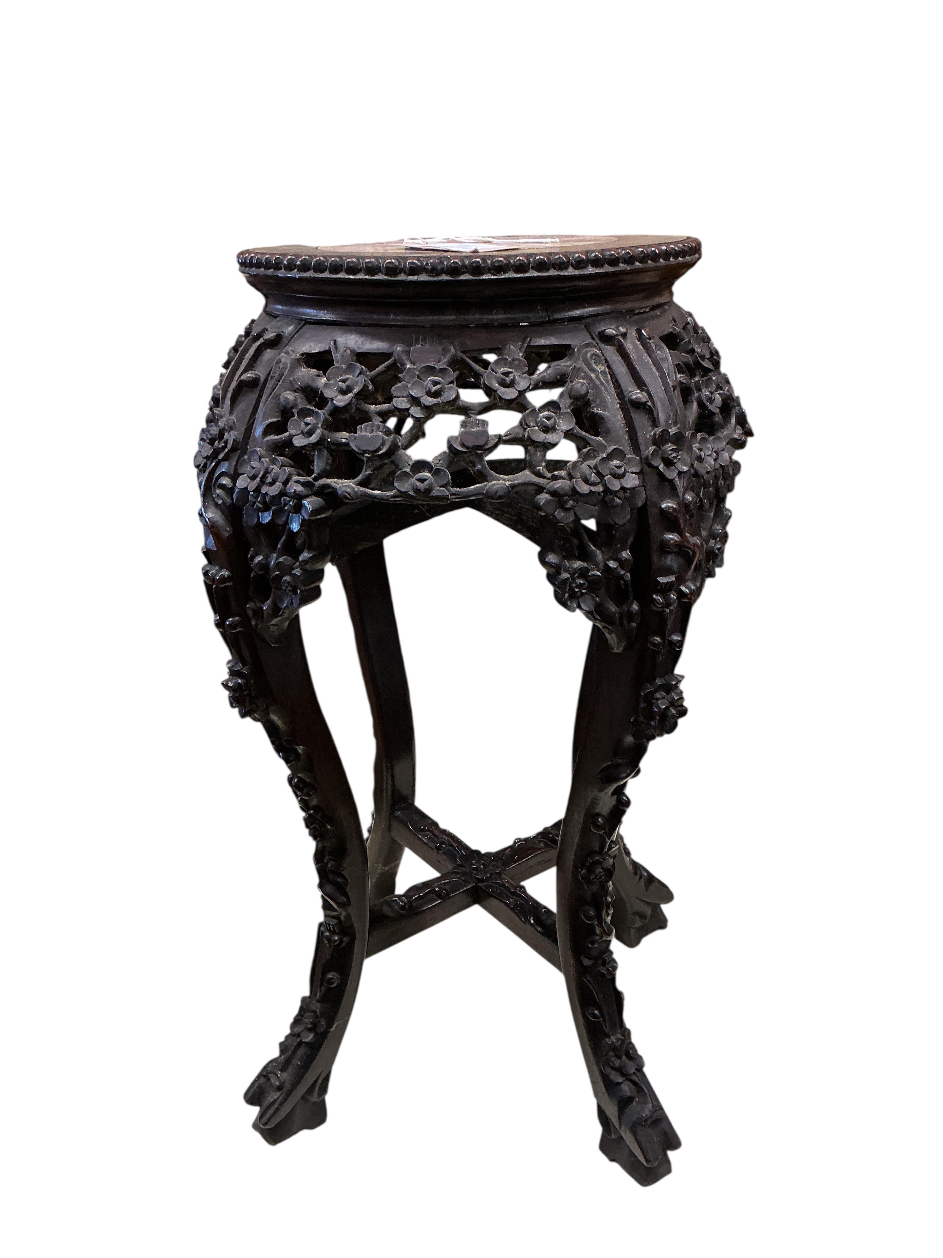 A Chinese carved padouk rouge marble topped jardiniere stand, height 60cm
